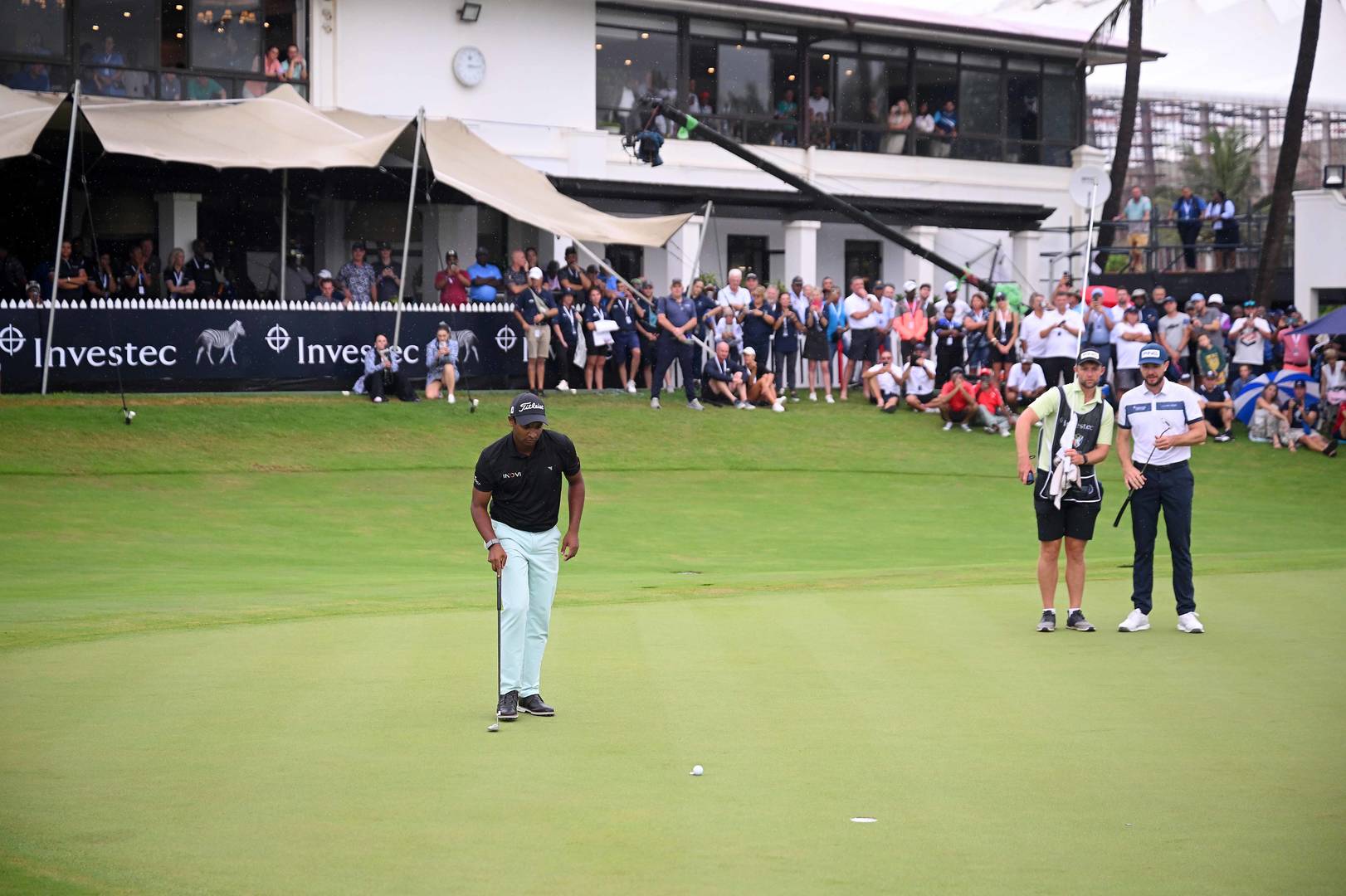 Dylan Naidoo lines up a putt during the Investec South African Open Championship in 2025.